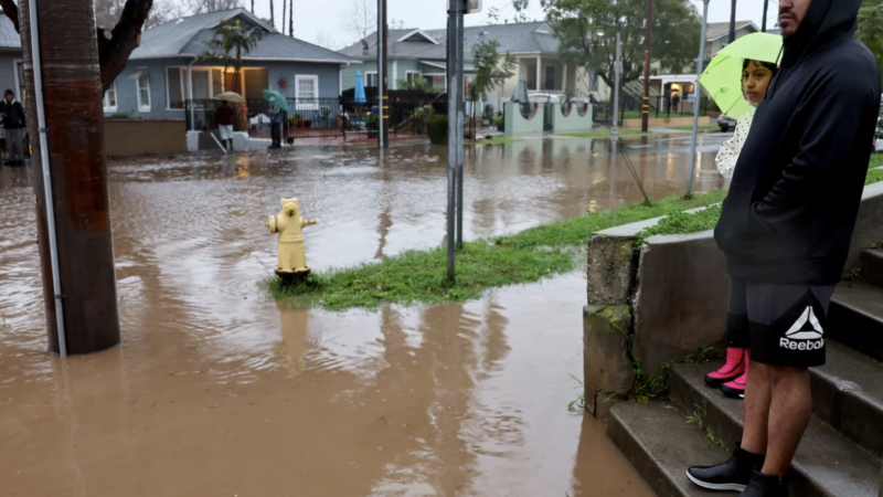 Residents stand along a flooded street in Santa Barbara, California, as a powerful atmospheric river pummels the region. The storm has caused landslides, power outages, and road and airport closures across Southern California. Mario Tama/Getty Images